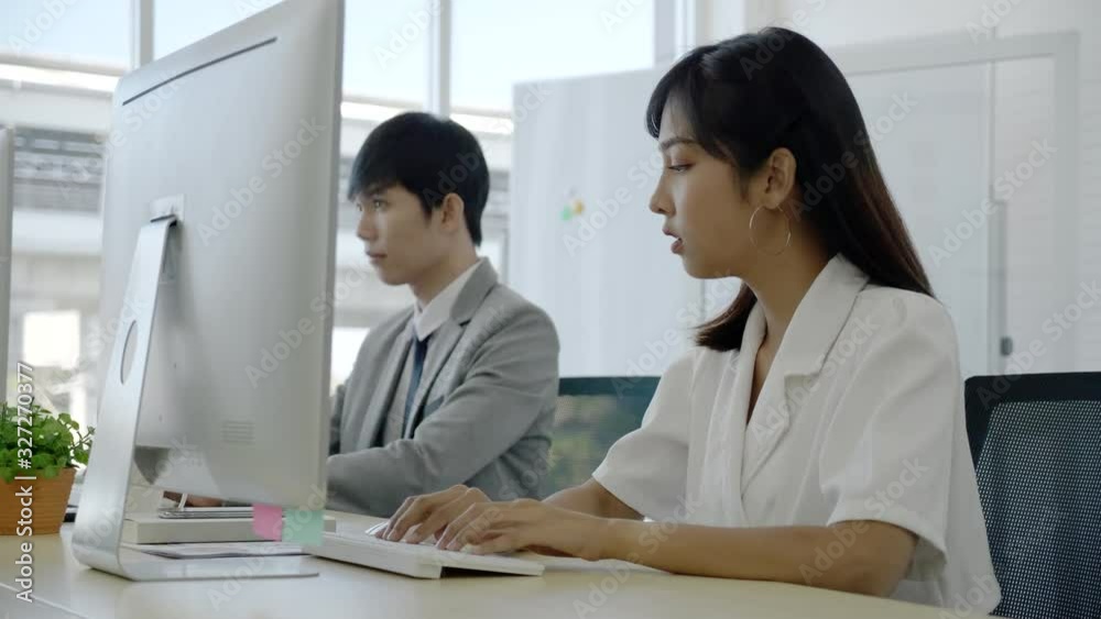 Asian business people woman sitting in modern office With colleague man Use computers to check market information. Strategic planning And use smartphone to chat with customers. Concept Business Merge Asian business people woman sitting in modern office With colleague man Use computers to check market information. Strategic planning And use smartphone to chat with customers. Concept Business Merge