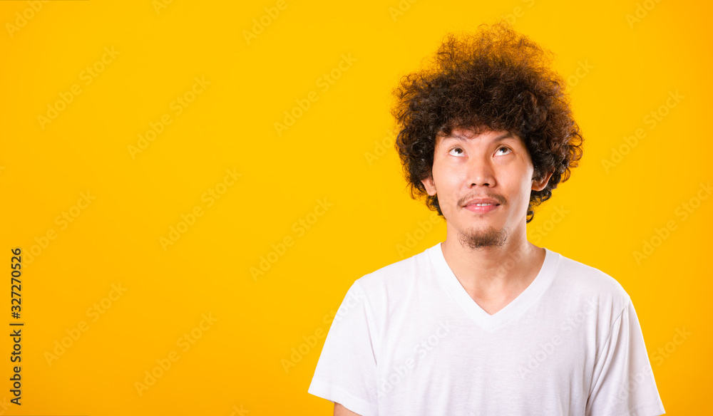 Asian handsome man with curly hair looking up see he hair isolate Asian handsome man with curly hair looking up see he hair isolate