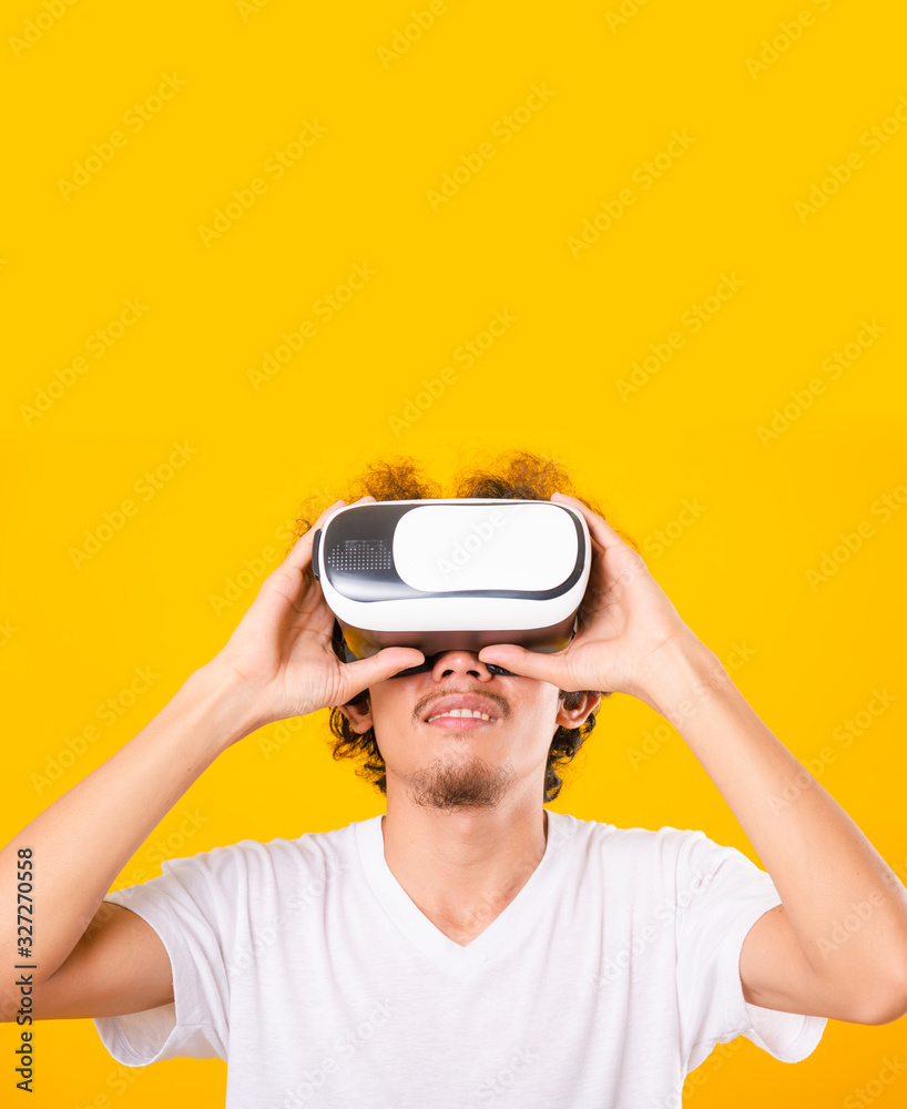 Asian handsome man with curly hair he using virtual reality headset or VR glass Asian handsome man with curly hair he using virtual reality headset or VR glass