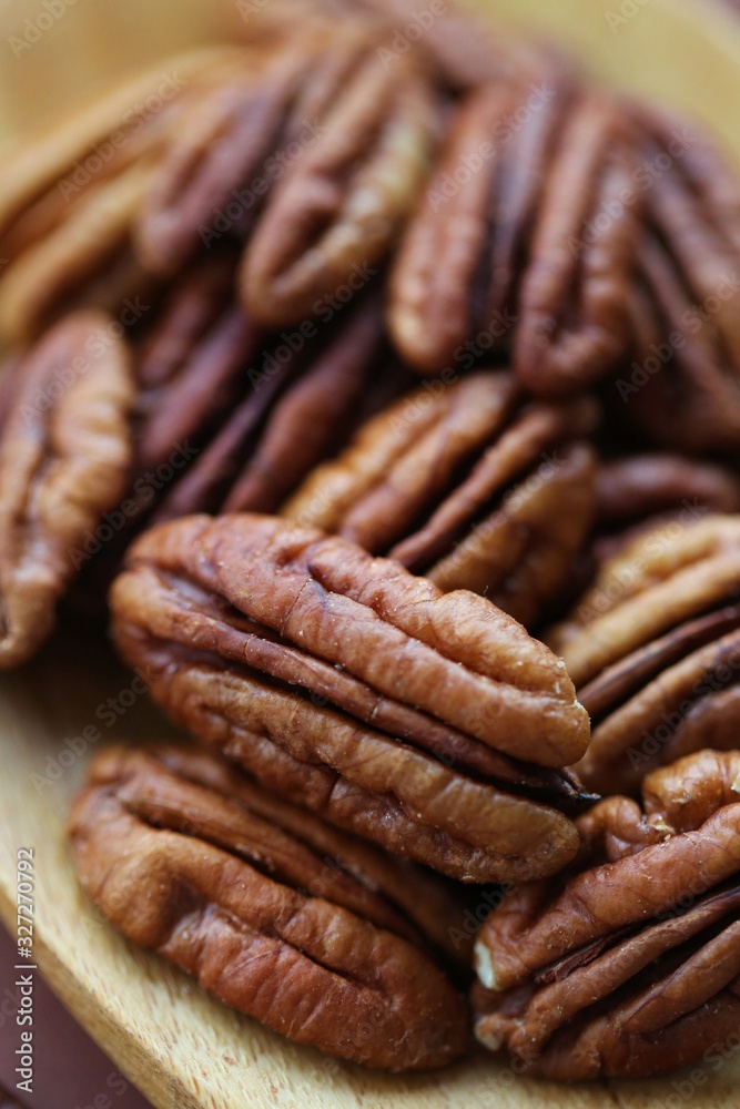 Pecan nut . Pecan texture. Useful products. Vegan and veggie nutrition ingredient. Low carbohydrate nutrition. Brown nuts background. Pecan nut . Pecan texture. Useful products. Vegan and veggie nutrition ingredient. Low carbohydrate nutrition. Brown nuts background.