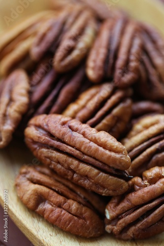 Pecan nut . Pecan texture. Useful products. Vegan and veggie nutrition ingredient. Low carbohydrate nutrition. Brown  nuts background.