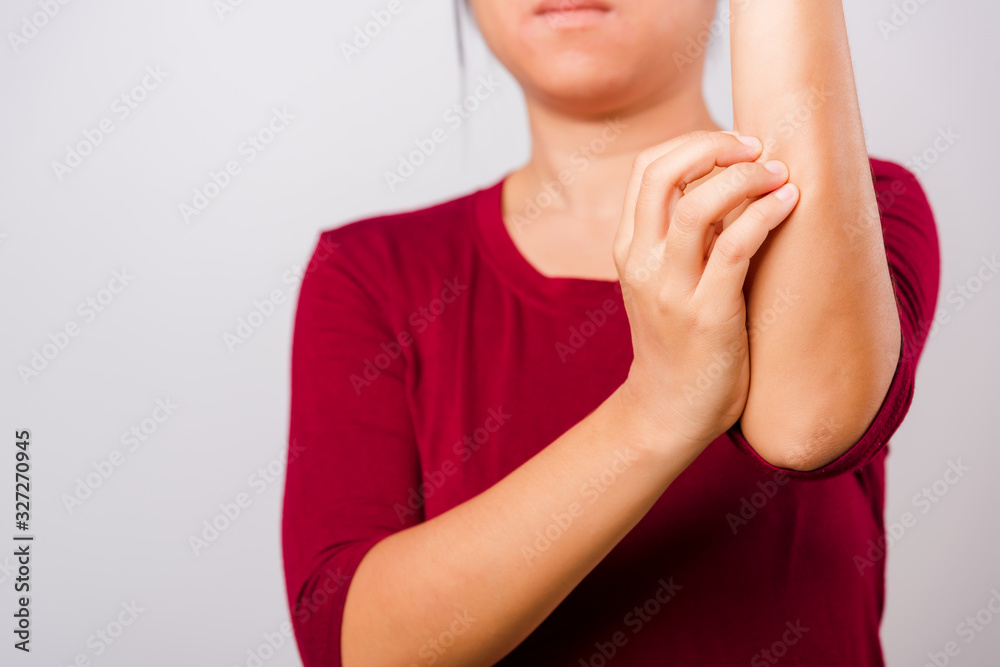 Asian beautiful woman itching her scratching her itchy arm Asian beautiful woman itching her scratching her itchy arm