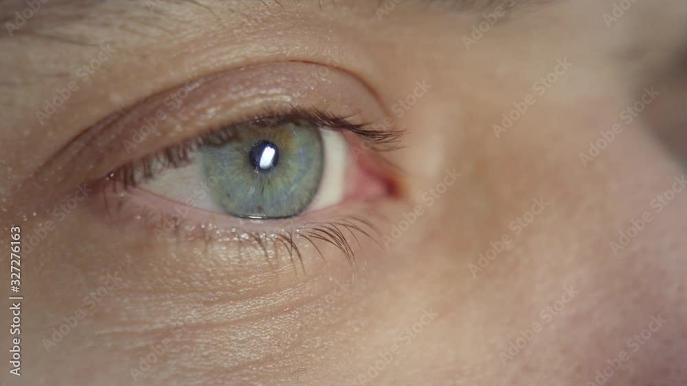 Extreme close up of man's grey green eye. UHD slow motion. Extreme close up of man's grey green eye. UHD slow motion.