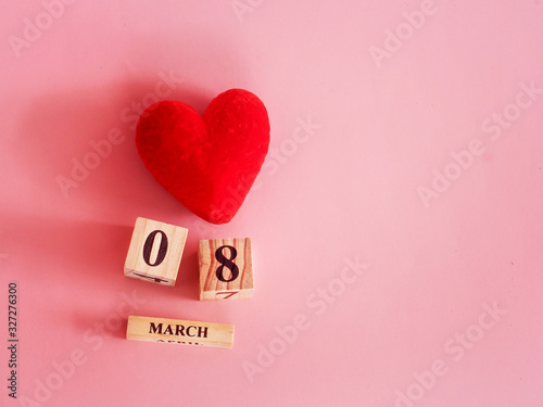 decoration of wooden date blog cube for 8 March , international women's day with a red heart shape on pink for celebration concept