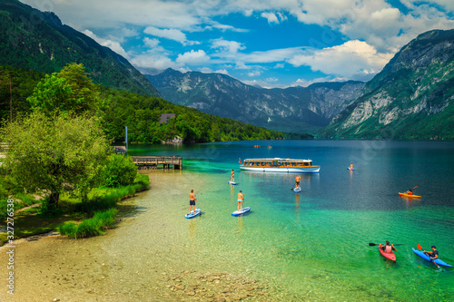 Fototapeta Naklejka Na Ścianę i Meble -  Active friends kayaking and paddling on the sup boards, Slovenia