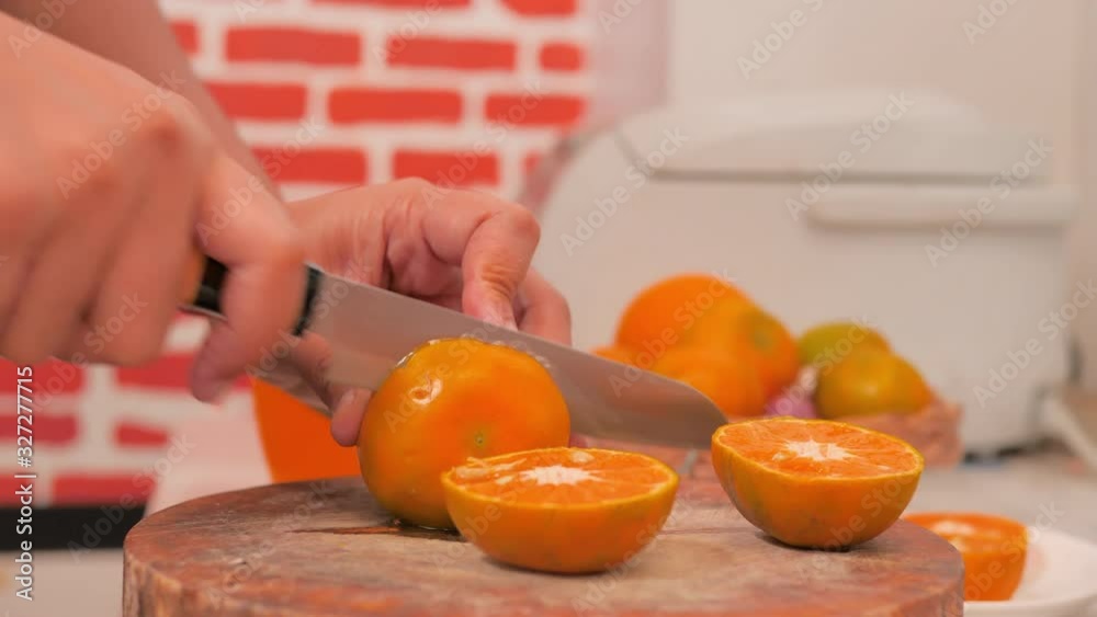 Collect oranges and cut in half on the cutting board in the kitchen. Collect oranges and cut in half on the cutting board in the kitchen.