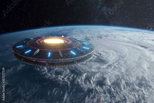 Fototapeta Naklejka Na Ścianę i Meble -  UFO, an alien plate hovered motionless in space against the background of the earth. alien invasion, spacecraft of the humanoids. Some elements of the image provided by NASA. mixed medium
