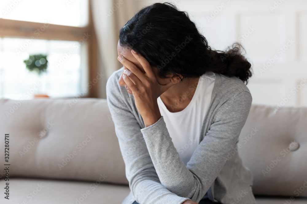 Unhappy biracial woman look in distance feeling depressed Unhappy biracial woman look in distance feeling depressed