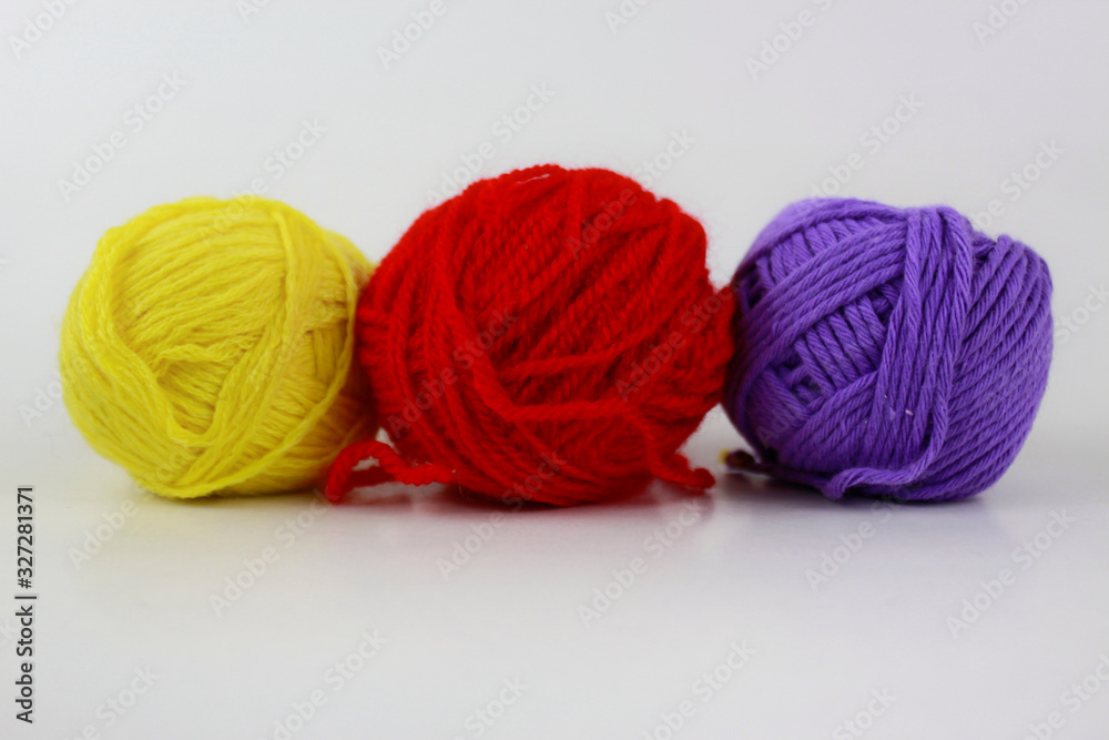 Yellow, red and purple yarn isolated on white background Yellow, red and purple yarn isolated on white background