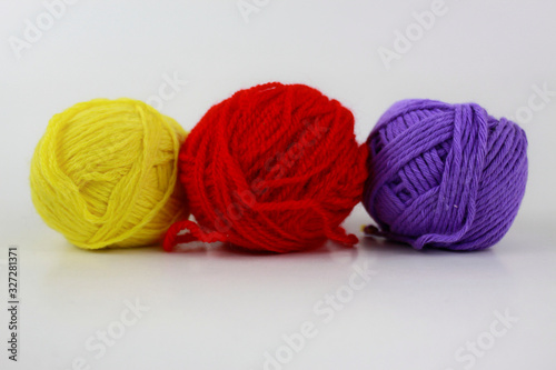 Yellow, red and purple yarn isolated on white background