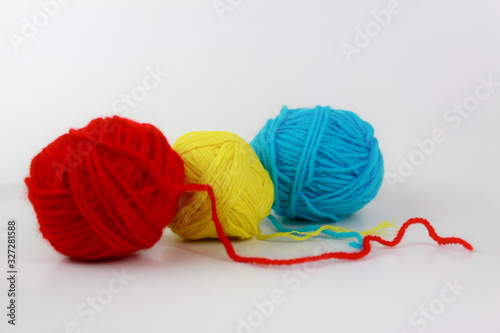 Red, yellow and cyan yarn closeup isolated on white background