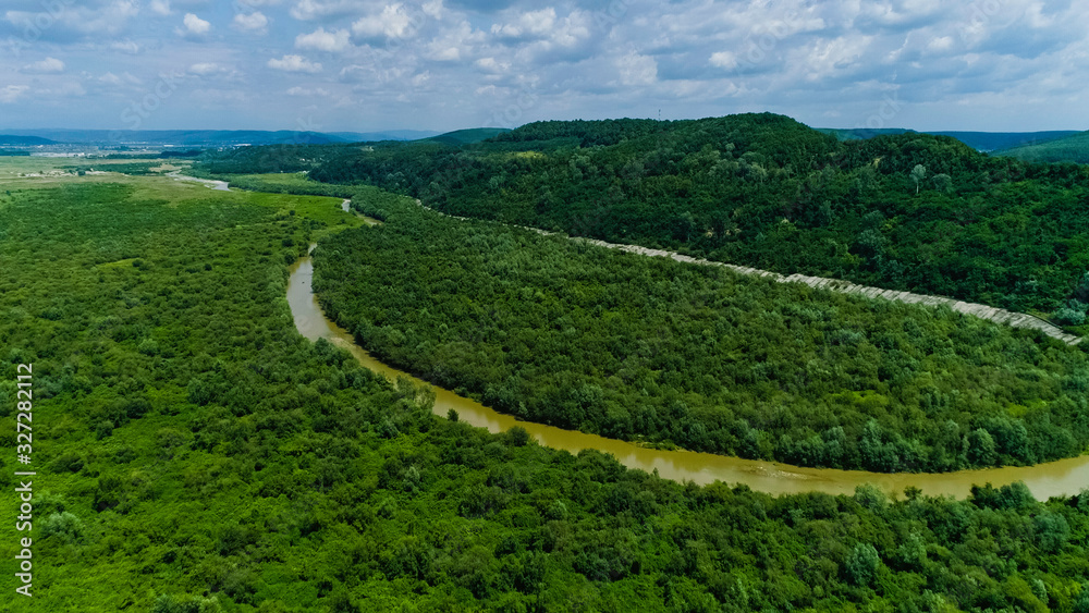 Drone view of a river crossing a beautiful forest landscape Drone view of a river crossing a beautiful forest landscape