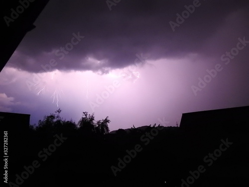 Lightning making the sky purple over a residential area