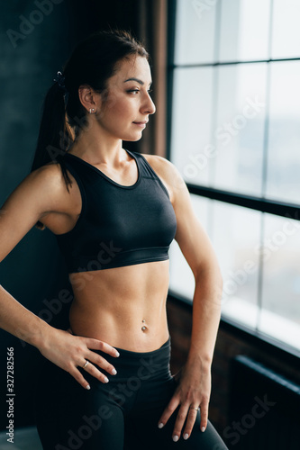 Fitness, sport and active lifestyle. Motivation. Intensive work out. Sweaty muscular body of sporty woman, close up © Vadym