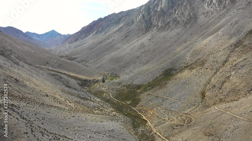 An aerial view inside Andes mountains at Limari Valley, south Atacama. An amazing wild scenery. Arid idyllic valleys with green farm fields feed in by the river at the bottom of the valley
 photo