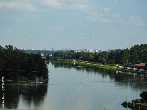 Water dam with city buildings on the horizon