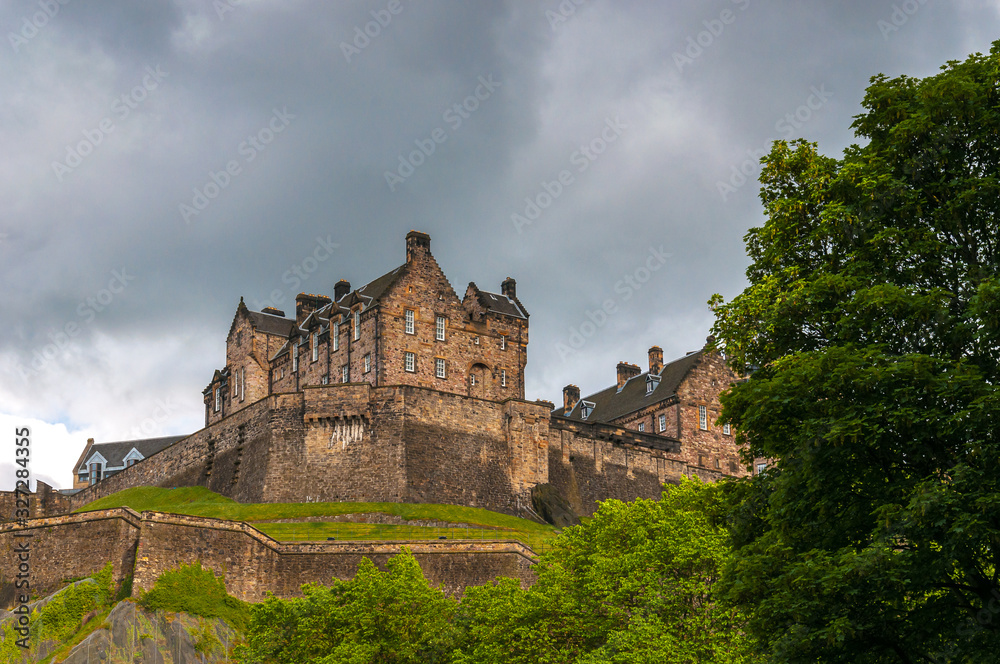 Edinburgh Castle silhouetted against a cloud-laden sky. Concept: famous castles of Scotland