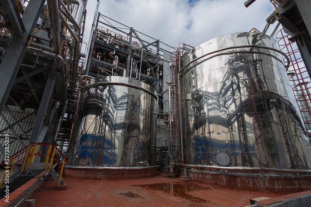 Reaction tanks at a chemical plant for the production of mineral fertilizers, nitric acid, ammonia, phosphorus fertilizers, ammonium, nitrate. In the daytime. Reaction tanks at a chemical plant for the production of mineral fertilizers, nitric acid, ammonia, phosphorus fertilizers, ammonium, nitrate. In the daytime.