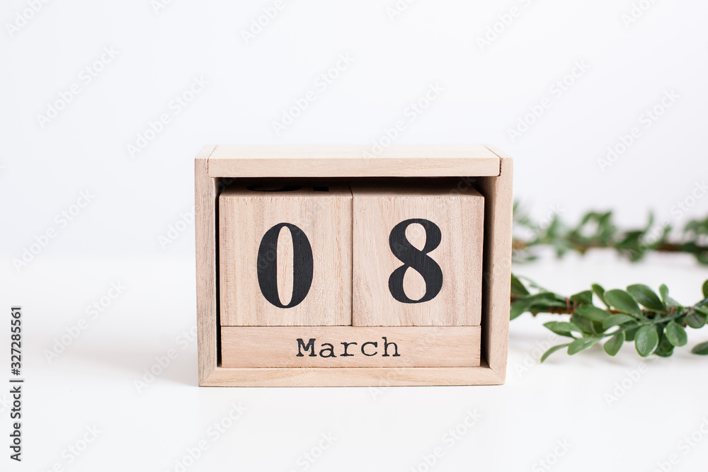 Wooden block calendar on white background. Calendar Women Day. copy space. Background for women's day. 8 March. Concept International Women's Day - March 8 message wooden brown blocks. Wooden block calendar on white background. Calendar Women Day. copy space. Background for women's day. 8 March. Concept International Women's Day - March 8 message wooden brown blocks.
