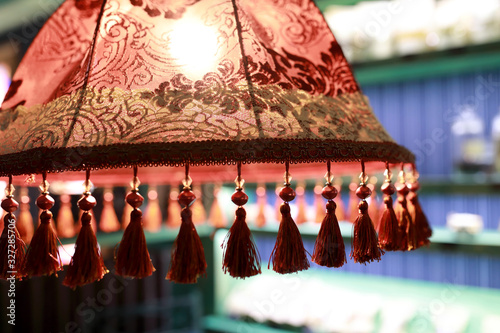 Fotografie View of red lampshade with tassels