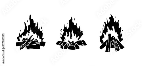 Set of monochrome vector illustrations isolated on a white background. Black silhouettes of burning bonfire. Outdoor adventure. Wild life. Camping hiking time.