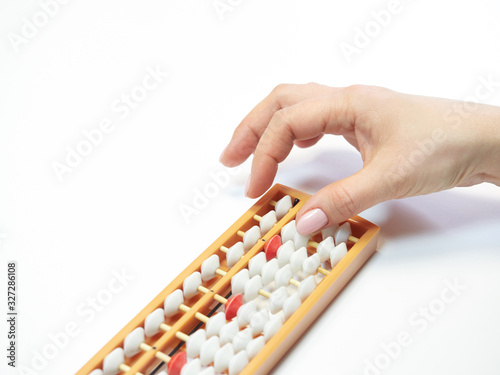Classes in mental arithmetic  hands and abacus soroban on white background. closeup. copy space
