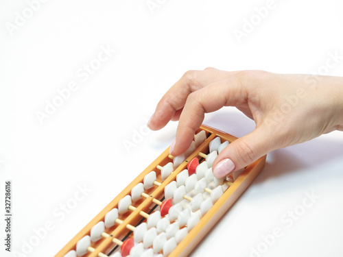 Classes in mental arithmetic  hands and abacus soroban on white background. closeup. copy space