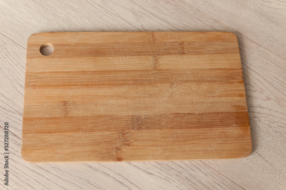 Empty wood cutting board on planks food background concept