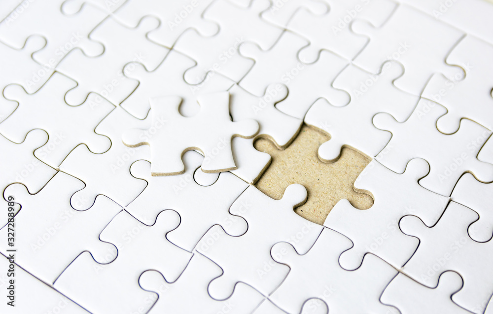 Fototapeta premium Fill the missing parts fragment of white jigsaw concept puzzle for succeed