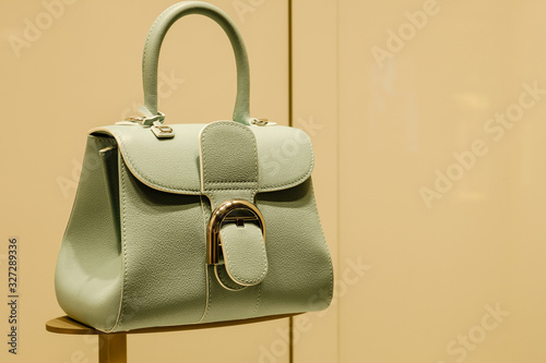 vintage style grey green color women handbag display on shelf