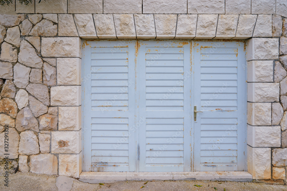 Ancient stone wall of old building with wooden vintage door. Ancient stone wall of old building with wooden vintage door.