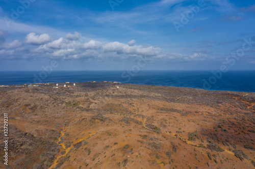 Aerial view of coast of Curaçao in the Caribbean Sea with turquoise water, cliff, beach and beautiful coral reef over Watamula