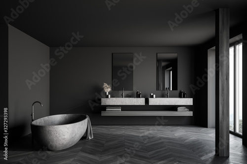 Gray bathroom with stone tub and column