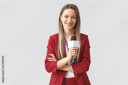 Female journalist on light background photo