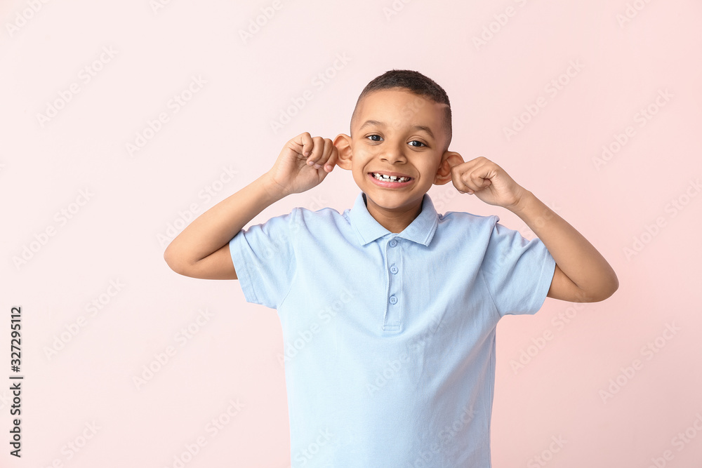 Grimacing African-American boy on color background Grimacing African-American boy on color background