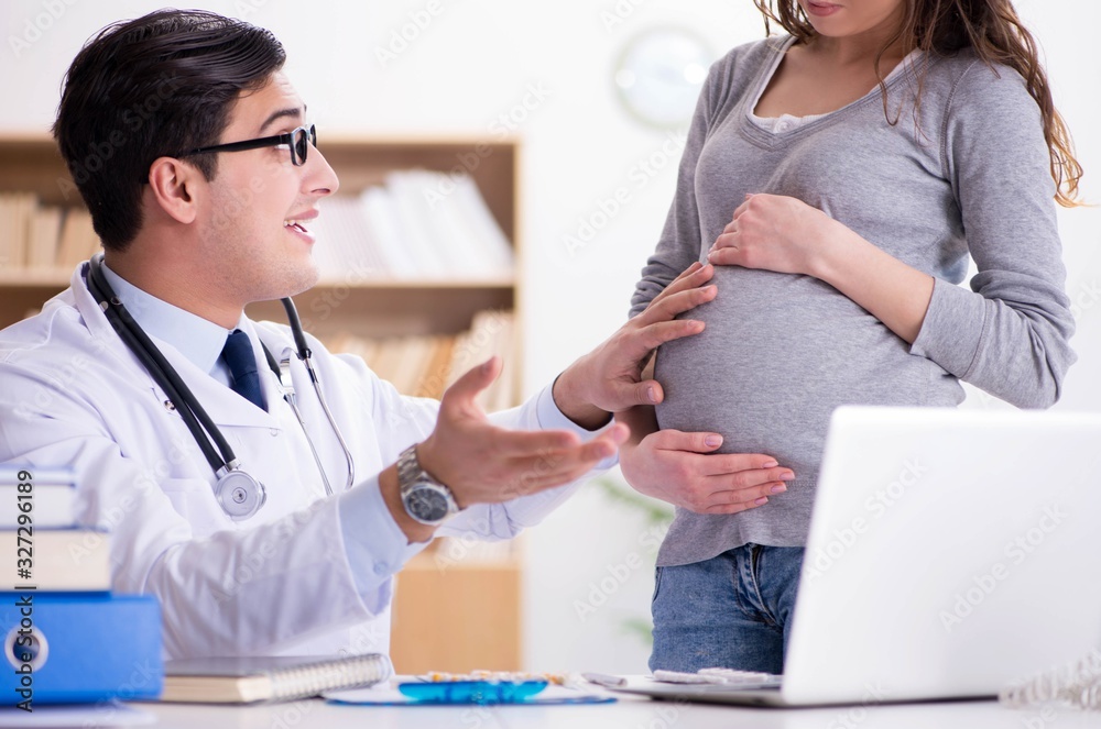 Fototapeta premium Pregnant woman visiting doctor for consultation