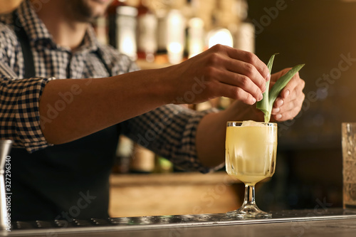 Fototapeta Bartender making cocktail in pub