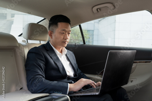 Asian business men work in cars © Allen Chen