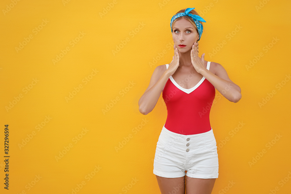Amazed young woman against yellow background. Amazed young woman against yellow background.