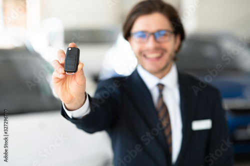 Agent Showing Car Key Standing In Automobile Rental Office