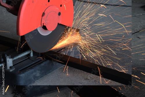  Man uses a metal cutting tool to create a red spark.