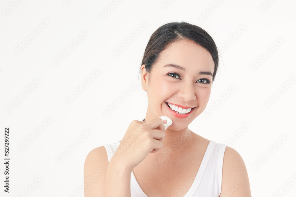 Beautiful Asian women skin treatment, use a sponge to wipe the face, beauty, attractive with a smile. White background Beautiful Asian women skin treatment, use a sponge to wipe the face, beauty, attractive with a smile. White background