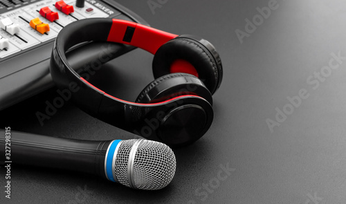Valokuva Microphone, headphones and audio sound mixer on black.