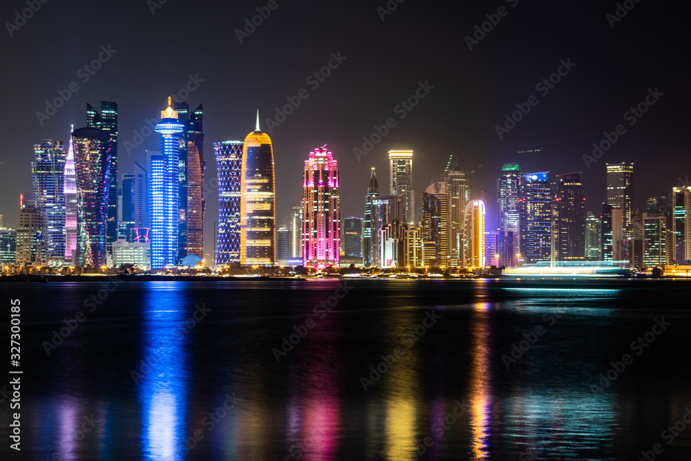 Obraz premium Vibrant Skyline of Doha at Night as seen from the opposite side of the capital city bay at night