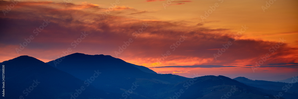 sunset, beautiful cloudy sky in carpathian mountains, summer landscape, spruces on hills