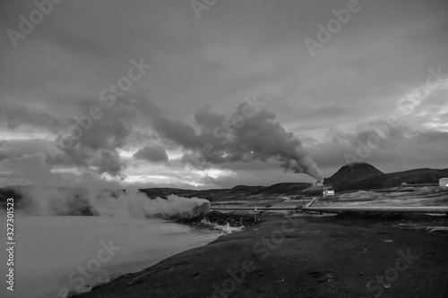 Blue Lake in Iceland geothermal hot lake turquoise water steam pipelines in black and white