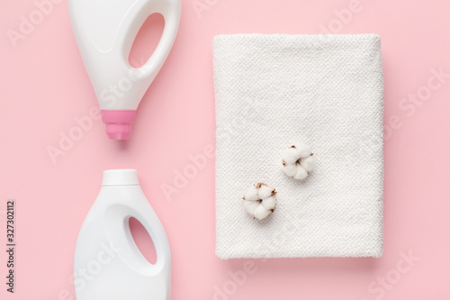 Bottles with washing detergent and cotton flowers on towel © Prostock-studio