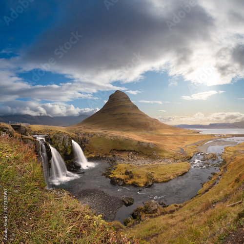 Kirkjufell in Iceland Kirkjufellsfoss waterfall and famous mountain under beautiful sunshine