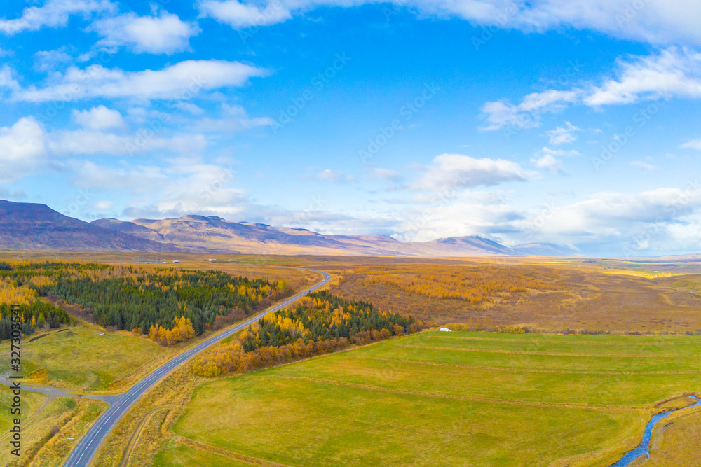 Northern Iceland during autumn aerial photo of trees and landscape turning yellow during nice weather