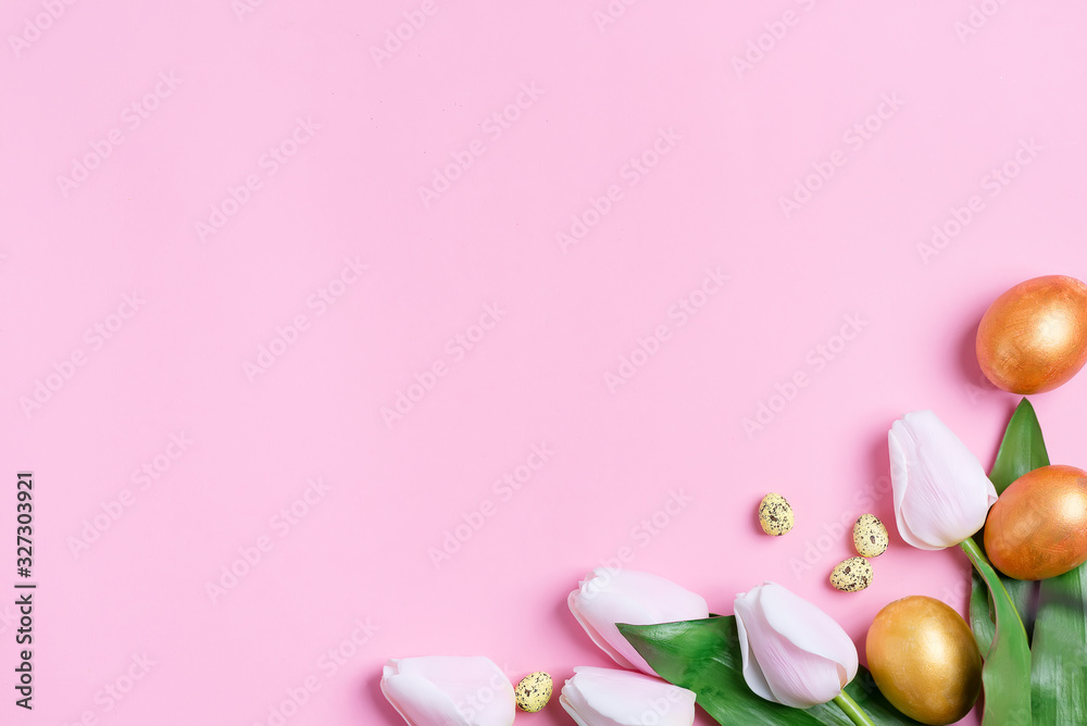 Corner festive frame from handmade golden painted eggs and fresh flowers on a pink background. Corner festive frame from handmade golden painted eggs and fresh flowers on a pink background.